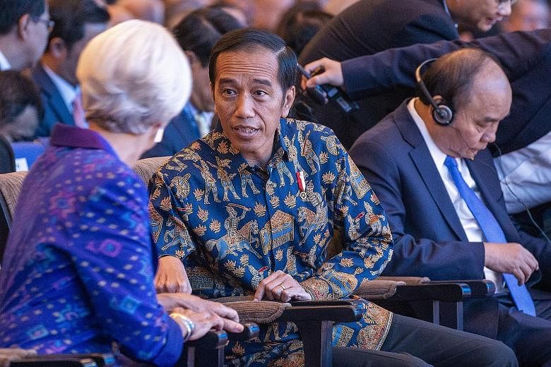 Indonesian President Joko Widodo and IMF managing director Christine Lagarde at the IMF-World Bank annual meetings in Nusa Dua, Bali, yesterday. Ms Lagarde proposed a "new multilateralism" that is "more inclusive, more people-centred and more result-