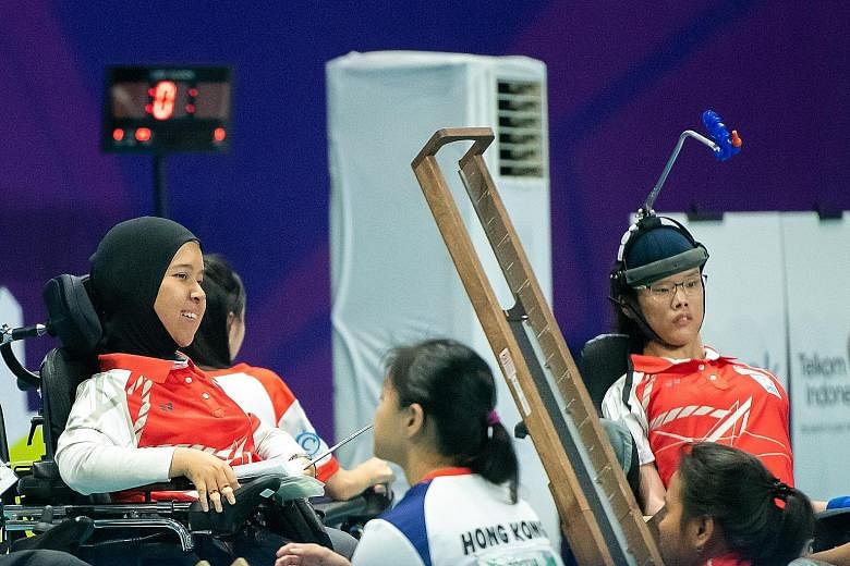 Boccia players Nurulasyiqah Taha (left) and Toh Sze Ning combined to win the silver medal in the mixed pairs BC3 event at the Asian Para Games yesterday. The duo lost 4-2 to Hong Kong in the final.