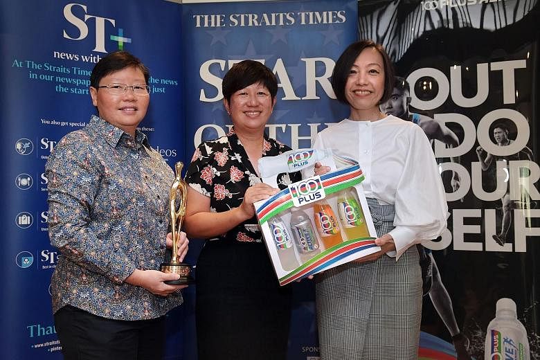 ST sports editor Lee Yulin (left) and Jennifer See, general manager for F&N Foods, presenting prizes to Monique Heah, team manager of the national equestrian team and honorary treasurer of the Equestrian Federation of Singapore.