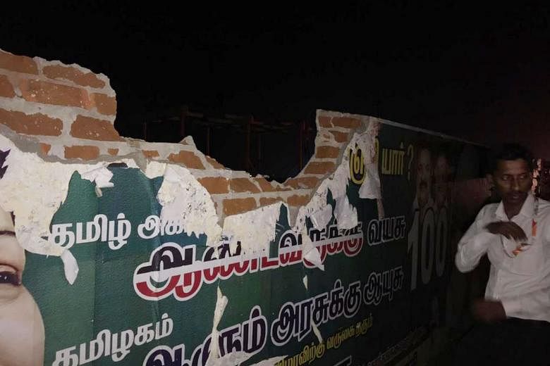 Fuselage of the shredded hull of the plane that hit the airport perimeter wall (below) in Tamil Nadu state last Friday. The jet landed safely in Mumbai four hours after the incident. The two pilots of the plane have been grounded, pending an investig
