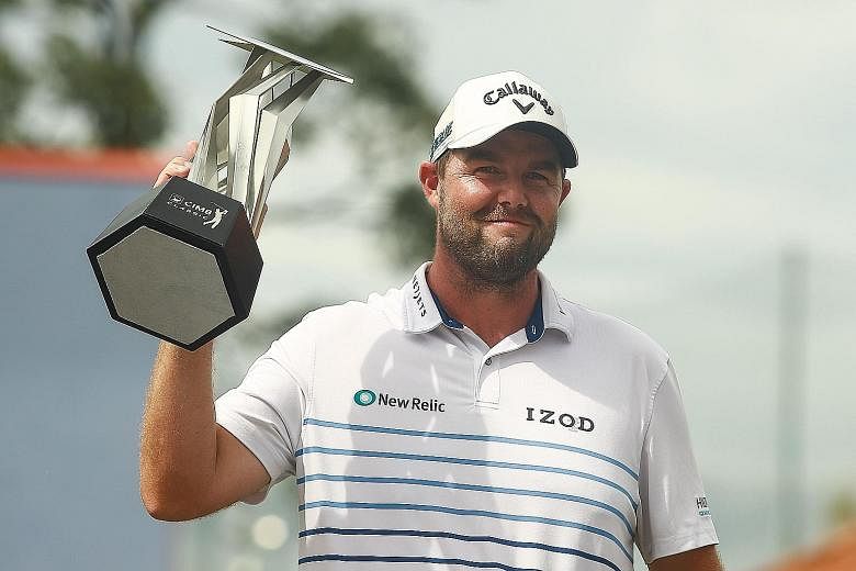 Australian golfer Marc Leishman lifting the CIMB Classic trophy yesterday after his five-stroke victory at the PGA Tour event.
