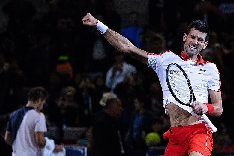 Novak Djokovic punching the air in delight after a clinical 6-3, 6-4 victory over Croatia's Borna Coric in the final of the Shanghai Masters yesterday. The Serb is only 215 points behind world No. 1 Rafael Nadal in his bid to claim the top ranking by