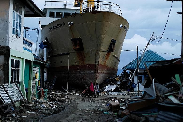 A stranded ship at a port hit by last month's deadly tsunami, triggered by a 7.4-magnitude tremor, in Palu in Central Sulawesi. The funds offered by the World Bank will go towards helping Indonesia shore up its defence against natural disasters, as w