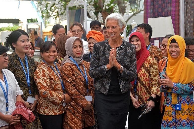 IMF managing director Christine Lagarde meeting organisers at a handicraft exhibition on the sidelines of the IMF-World Bank meetings in Bali yesterday. She described the meetings, which drew 36,669 delegates and other participants from all over the 