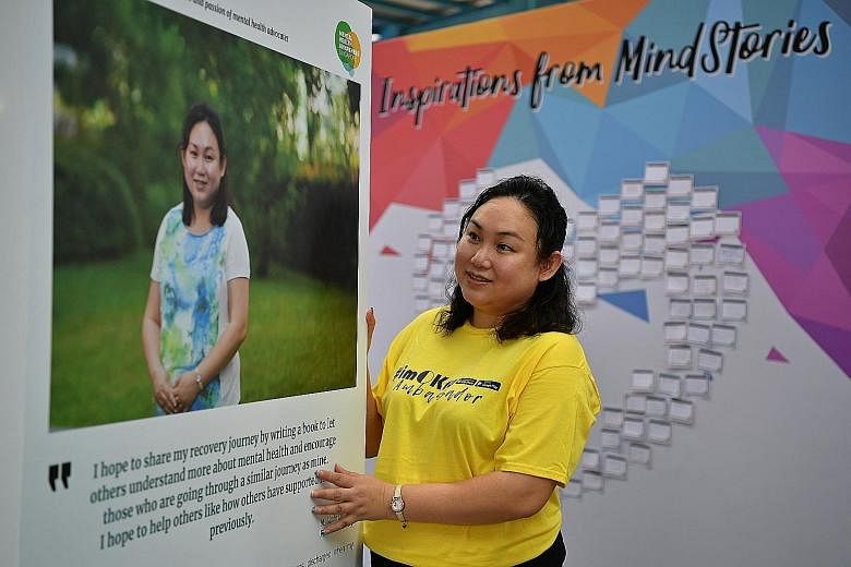 Ms Linda Chua, who was diagnosed with bipolar disorder, with the panel sharing her story at the MindStories exhibition at Ang Mo Kio Central Stage yesterday. The AMKFSC volunteer wants to help people overcome their own mental health disorders.