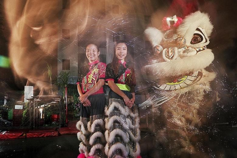 Bank officer Stella Chua (left) and visual merchandiser Leow Hui Zhi are among a small but growing number of women competing in lion dance championships.