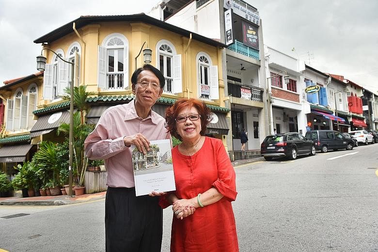 Mr Yap Boh Tiong with the book he initiated, On A Little Hill In Chinatown: Singapore's Ann Siang Hill. With him is Ms Wong Kok Yee, managing director of Tin Sing Goldsmiths. They are standing in front of the building in Club Street that inspired the