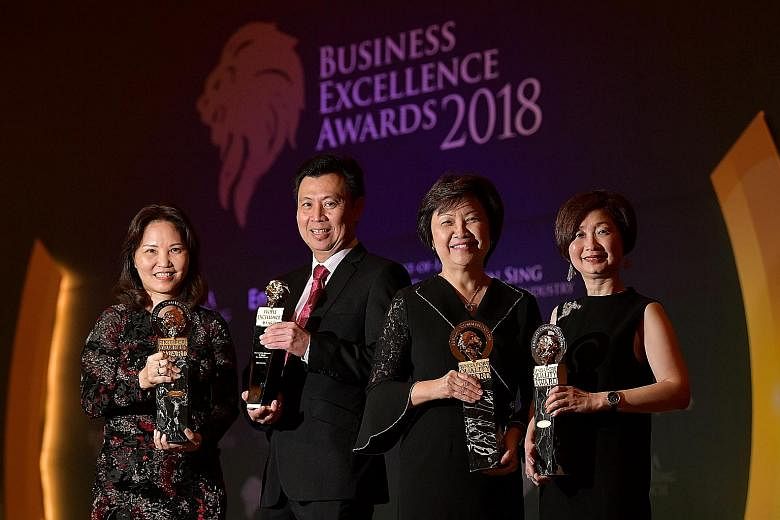 Receiving Business Excellence Awards yesterday on behalf of their organisations were (from far left) Institute of Technical Education CEO Low Khah Gek, Beca Carter Hollings & Ferner (South-east Asia) managing director Lee Ang Seng, Housing Board CEO 