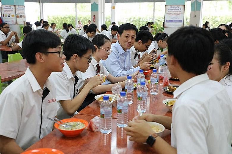 Some students from Northland Secondary School having a meal with Education Minister Ong Ye Kung yesterday in their school canteen. In a Facebook post yesterday, Mr Ong said he encouraged the students to focus on learning, amid recent changes to reduc
