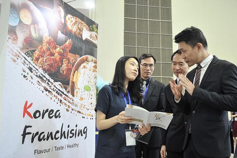Mr Baey Yam Keng (right) visiting the Korea Pavilion led by the Korea Agro-Fisheries & Food Trade Corporation.