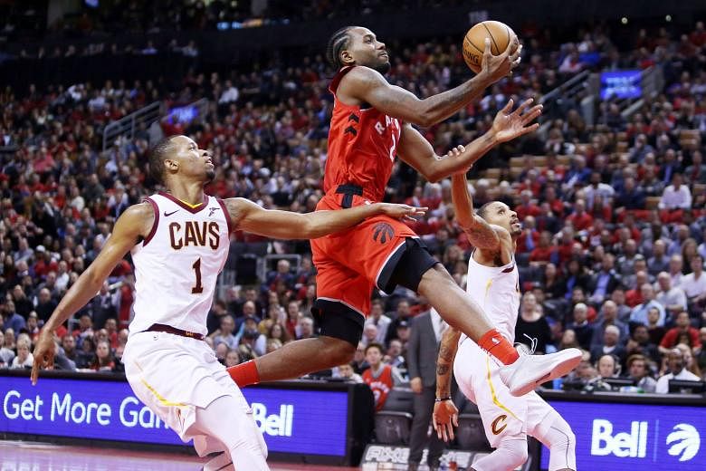 Kawhi Leonard on his way to a lay-up as Rodney Hood (No. 1) and George Hill of the Cleveland Cavaliers fail to stop the Toronto Raptors star at the Scotiabank Arena.