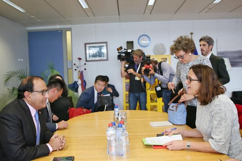 Minister-in-charge of Trade Relations S. Iswaran (left) and EU Trade Commissioner Cecilia Malmstrom at a bilateral meeting at the European Commission headquarters in Brussels yesterday before the opening ceremony of the Asia-Europe Meeting.