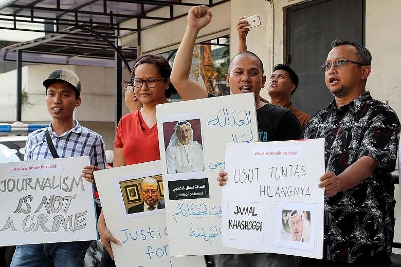 Indonesian journalists holding posters calling for a complete investigation into the disappearance of Saudi journalist Jamal Khashoggi during a protest in front of the Embassy of Saudi Arabia in Jakarta yesterday. Mr Khashoggi was last seen entering 