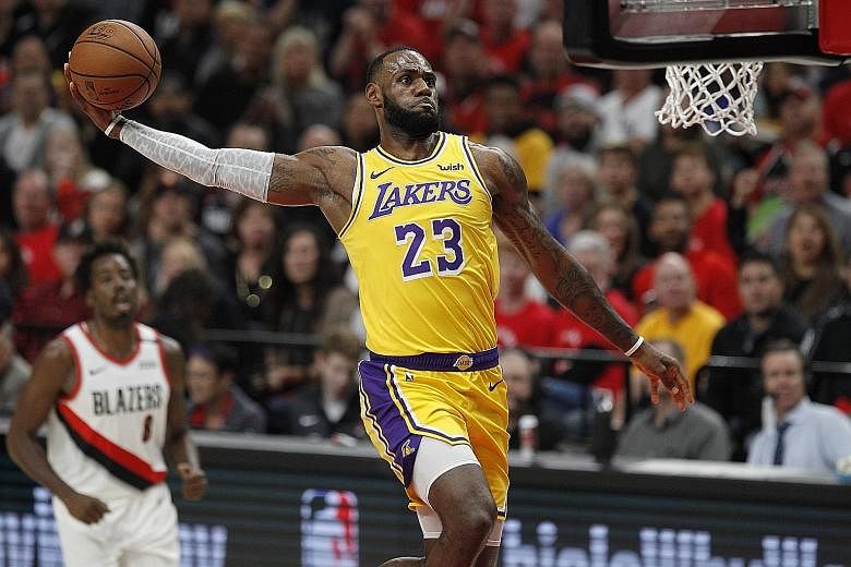 Los Angeles Lakers forward LeBron James soars to the hoop for a dunk against the Portland Trail Blazers in Thursday's 128-119 loss. The Lakers have lost to Portland 16 times in a row.