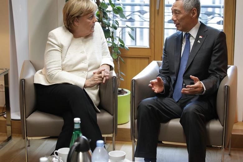 Prime Minister Lee Hsien Loong meeting German Chancellor Angela Merkel (left) and British Prime Minister Theresa May in Brussels on Thursday, where they underscored their commitment to the multilateral system.