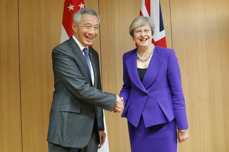 Prime Minister Lee Hsien Loong meeting German Chancellor Angela Merkel (left) and British Prime Minister Theresa May in Brussels on Thursday, where they underscored their commitment to the multilateral system.