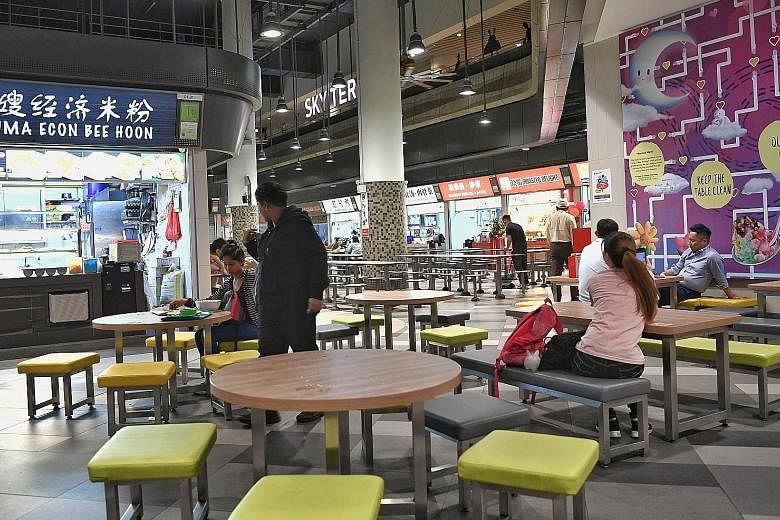 2.50amHawker centre workers resting in the quiet night. There are now 16 stalls open 24 hours a day out of 42, down from 36 in 2016. 2am Hawker Alex Hoong serving junior college student Tan Yun Wee a bowl of Korean ramen noodles. Mr Hoong's Korean fo