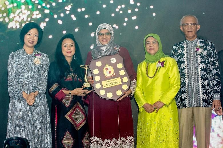 Ms Bibi Fatimah Sheikh Muhammad (centre), 55, was presented with the Exemplary Mother Award, which honours mothers from all walks of life who have made an impact on their family members and the community, from Muslim organisation Jamiyah Singapore ye