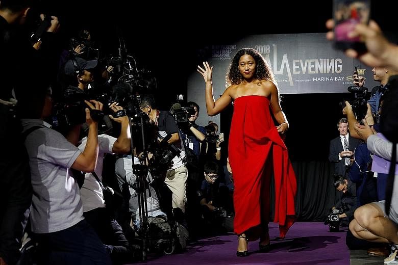 Japanese tennis star Naomi Osaka arriving for the singles draw ceremony of the WTA Finals on Friday. Feeling like a fish out of water on the catwalk, Osaka says she would be way more comfortable walking on the tennis court.