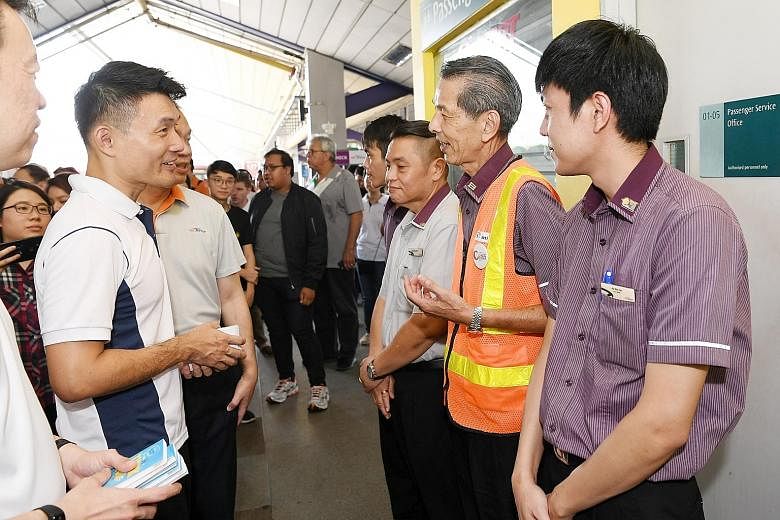 Mr Baey Yam Keng (at far left) speaking to public transport workers from SBS Transit at Tampines Bus Interchange after the launch of the Public Transport Workers' Appreciation Campaign yesterday.