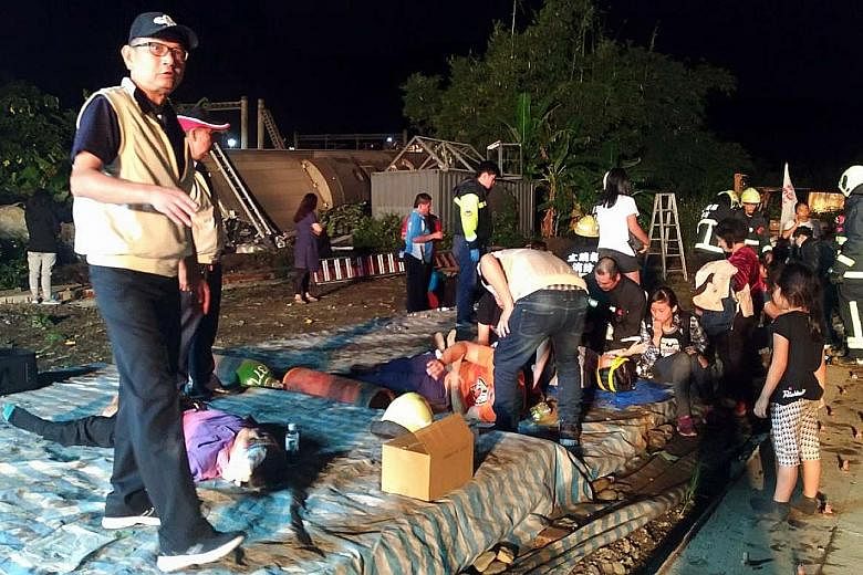 A Taiwan Defence Ministry photo showing rescuers attending to victims of the train accident in Yilan yesterday. Hundreds of medics and firefighters have been dispatched to the scene. The army is also sending 100 troops.