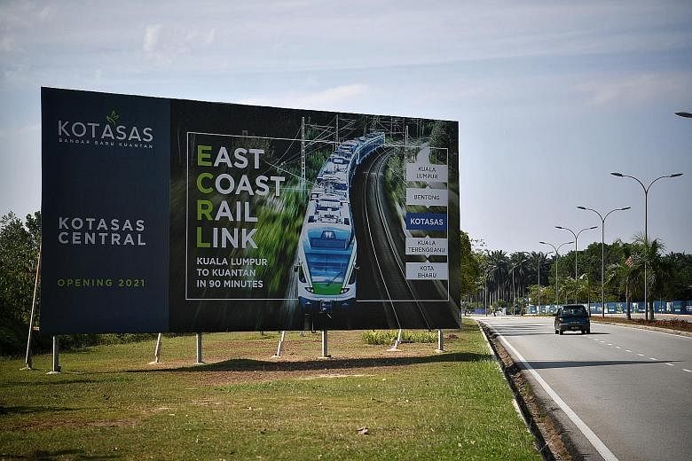 A billboard in Kuantan highlighting the East Coast Rail Link. The Malaysian government is in discussions on whether to scrap the project.