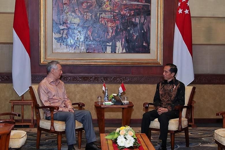 Prime Minister Lee Hsien Loong meeting Indonesian President Joko Widodo at a retreat in Bali earlier this month.