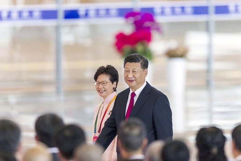 Chinese President Xi Jinping and Hong Kong Chief Executive Carrie Lam at the opening ceremony of the new bridge yesterday. The new 55km crossing costs S$27.6 billion and joins two former European colonies to the Pearl River Delta in Guangdong to form
