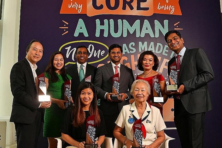 The recipients of the President's Volunteerism and Philanthropy Awards are (clockwise from back row) Associate Professor Peter Pang, representing the National University of Singapore; Ms Emily Teng, founder of Blessings in a Bag; Mr Adam Abdur Rahman