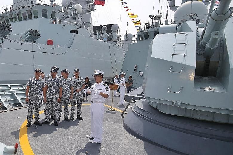 Crew from the Republic of Singapore Navy frigate RSS Stalwart getting a tour on board the Chinese frigate Huangshan on the third day of the Asean-China Maritime Field Training Exercise.
