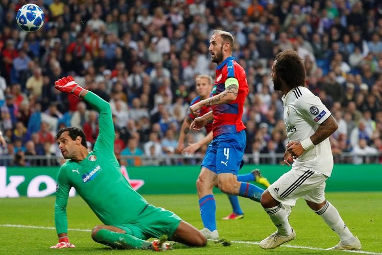 Real Madrid's Marcelo (right) scoring his team's second goal against Viktoria Plzen to win 2-1 and end their five-game winless streak.