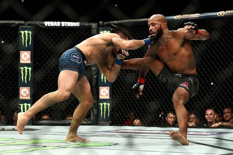 Demetrious Johnson trying to fend off Henry Cejudo in the fourth round of the flyweight title bout at UFC 227 in Los Angeles' Staples Centre on Aug 4. Johnson's loss came in his 12th title defence.