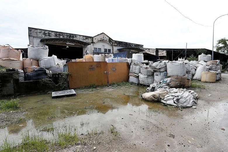 Above: Plastic waste outside an illegal recycling factory in Jenjarom in Kuala Langat, Malaysia, earlier this month. Left: An illegal plastic recycling factory in Pulau Indah. Many illegal plants use low-end technology and environmentally harmful met