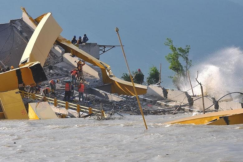 Workers clearing up at the site of a bridge damaged by the earthquake-tsunami in Palu, Indonesia, last month. Indonesia's National Disaster Management Agency has warned that the country is likely to face more natural disasters as it enters the year-e