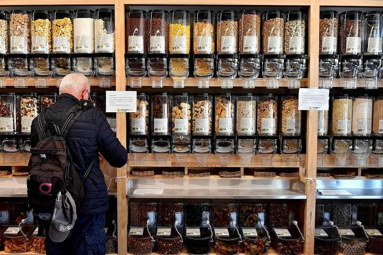 A man buying dried fruit in an organic supermarket in France earlier this month. Experts have raised problems about a recent French study showing that the most avid eaters of organic food had fewer cancers.