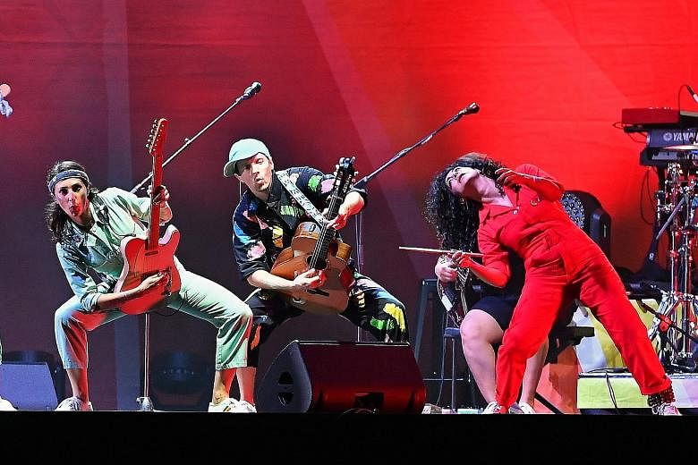 Jason Mraz (centre above and right) and his musicians' colourful coveralls match the concert's positive vibe.