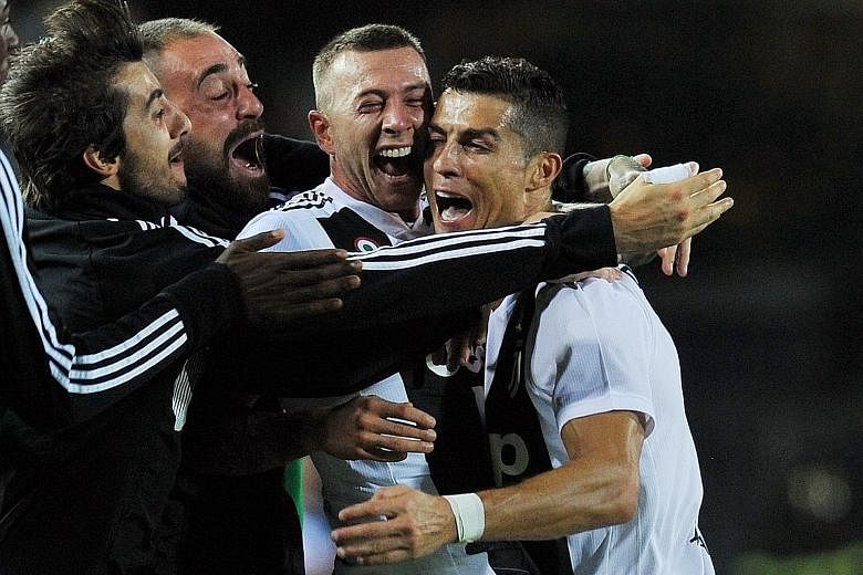Cristiano Ronaldo celebrating what proved to be the winner against Empoli with his teammates. The Portuguese forward's long-range strike gave the Serie A leaders a 2-1 victory.
