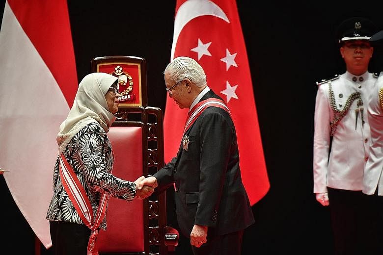 Dr Tony Tan Keng Yam, former president, receiving the Order of Temasek (First Class) award, the nation's highest civilian honour, from President Halimah Yacob yesterday. Mr Hsieh Fu Hua received a Meritorious Service Medal for being "a strong advocat