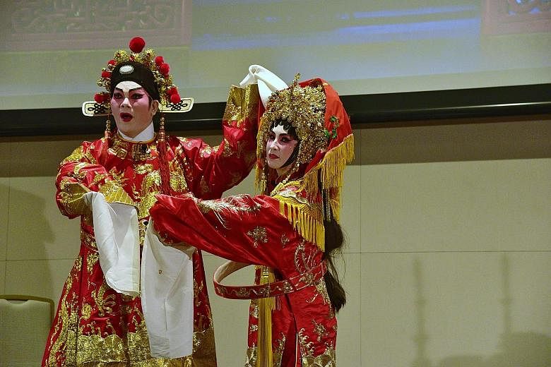 Left: Mr Teo Eng Hock and Ms Choo Mui Eng performing an excerpt from the Cantonese opera Di Nu Hua, which tells the story of Princess Changping of the Ming Dynasty, at the book launch. Above: The book, Flying Sleeves - The Grandeur of Chinese Opera, 