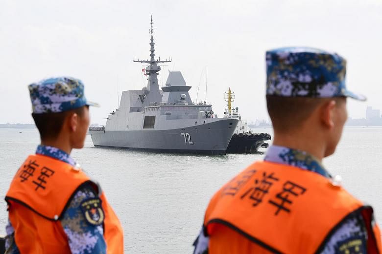 Chinese sailors watching as a Republic of Singapore Navy ship arrives at a military port in Zhanjiang, in China's Guangdong province, on Oct 21. The joint Asean-China maritime exercise took place at a time of increased tension in the South China Sea.