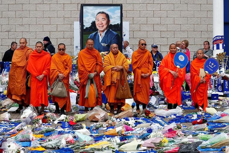 Buddhist monks standing in tribute following prayers for Leicester's late owner Vichai Srivaddhanaprabha and four others who died when their helicopter crashed as it left the ground after last Saturday's match against West Ham.