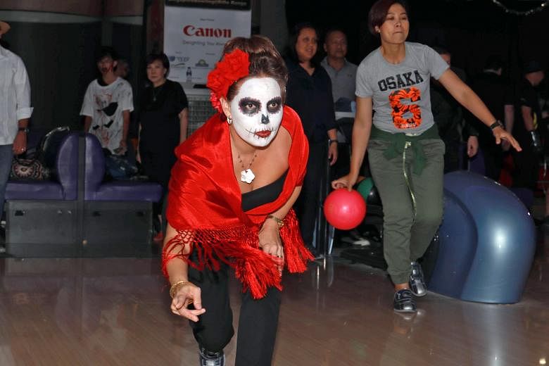 Over 200 guests, including US Embassy charge d'affaires Stephanie Syptak-Ramnath (above), attended the Zombie ABOWLcalypse at the Canon Ambassador Night at SingaporeBowling@Rifle Range yesterday. Organised by the Singapore Bowling Federation (SBF) to