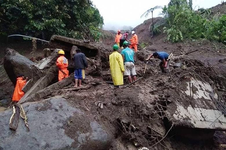 Rescuers looking for survivors after a landslide in Natonin, Mountain province, yesterday.