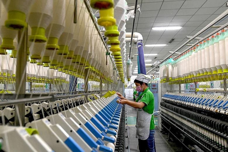 An employee at a textile factory in Shangqiu, Henan province. The statement from China's politburo meeting signalling that further stimulus measures are being planned came hours after purchasing manager reports showed an across-the-board deterioratio