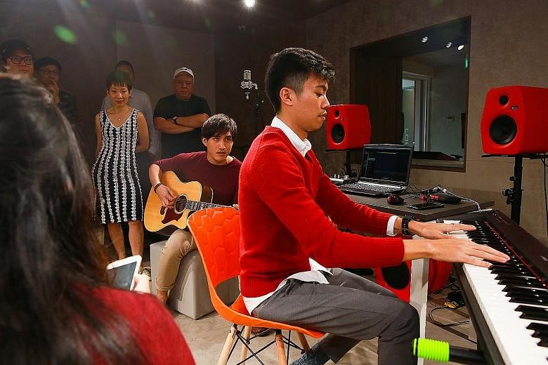 Music producer Joshua Goh, 26, on keyboard, and freelance musician Marcus Lee, 26, on guitar, composing a chorus at The Songwriter Music College, a partnership between content producer mm2 Asia and music company Funkie Monkies.
