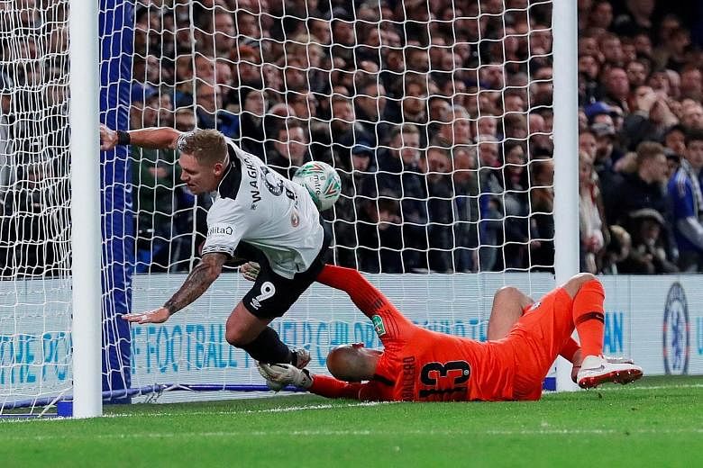 Top: Derby County striker Martyn Waghorn scoring his team's second equaliser past Chelsea goalkeeper Willy Caballero shortly before the half-hour mark in the 3-2 League Cup round-of-16 loss at Stamford Bridge on Wednesday. Above: Former Chelsea star 