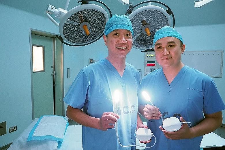 Associate Professor Tan Ngian Chye (at left) and Dr Kevin Koh with the Klaro, a lighting device that is used for open surgery and is cooler than regular LEDs, so it does not damage any surrounding body tissue. A procedure being done with the lighting