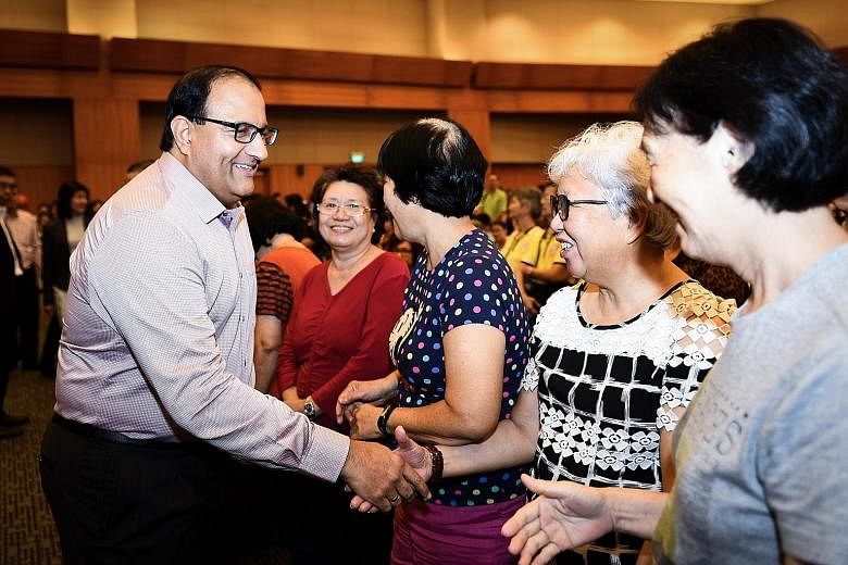 Mr S. Iswaran greeting attendees at the Institute of Technical Education College East's Service Learning Day yesterday, where students held a series of events for seniors, including on how to identify fake news.