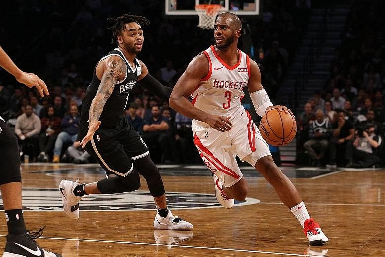 Houston Rockets' point guard Chris Paul driving the ball around the Brooklyn Nets' D'Angelo Russell on his way to a season-high 32 points and 11 assists at the Barclays Centre on Friday.