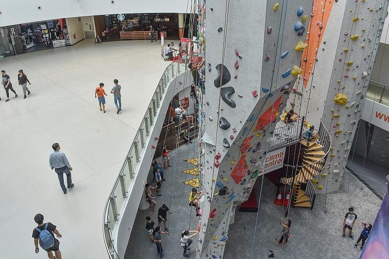 The future of retail includes malls transforming themselves and having standout features, like this rock wall in Kallang Wave Mall that provides a sensory experience for customers, besides providing a selection of stores.
